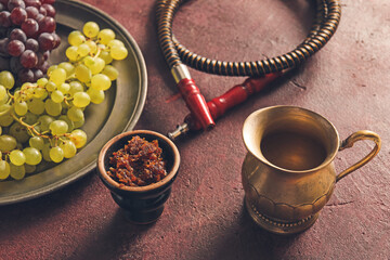 Obraz na płótnie Canvas Parts of hookah, tobacco and grape on grunge background