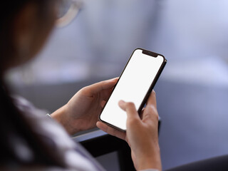 Female office worker relaxing with smartphone in office room