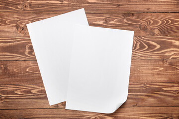 Blank paper sheets on wooden background