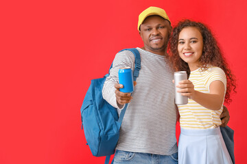 African-American couple with soda on color background