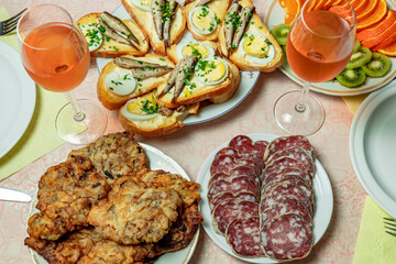 Festive table with rose wine and appetizers.