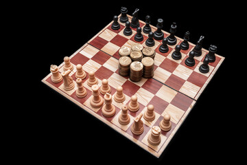 Business competition concept. Struggle of two chess teams for money capital on chessboard against black background. Golden coins on chessboard. Battle for money