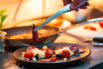 Chef plating food in a restaurant.