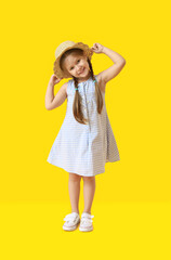 Portrait of stylish little girl on color background