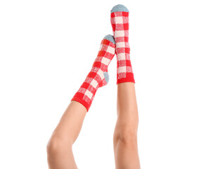 Legs of young woman in socks on white background