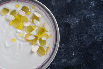 Spanish dish, cold soup ajo blanco or ajoblanco from garlic, almonds, white wine vinegar, olive oil and grapes