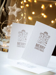 Three white postcards with the inscription merry Christmas with festive decorations