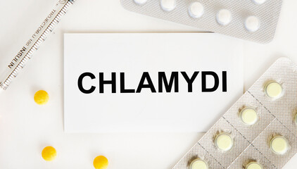 On the business card tekts CHLAMYDIA, near blisters with tablets, syringe.
