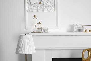 Mantelpiece with candle holders in stylish interior of room