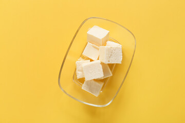 Box with fresh butter on color background