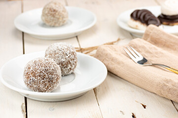 Coconut cake, name coconut ball. Filled with mixed filling. Traditional christmas dessert ideal for long term storage.  Served on old retro white table.