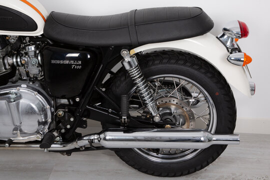 Triumph bonneville back rear detail of t100 motorcycle in vintage style retro