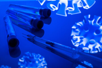 Virus protection. Medical syringe with needle for protection flu virus and coronavirus. Covid vaccine isolated on blue. Syringe, medical injection.