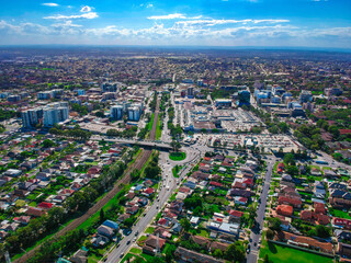 Panoramic Aerial View of Sydney Western suburbs showing house roof tops roads cars and other buildings 