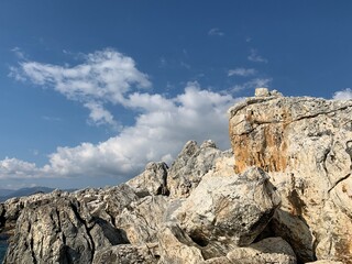 Rocky sea stones in the blue sky background, coast