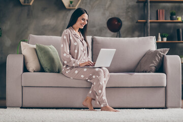 Obraz premium Profile photo of nice optimistic girl sit write laptop wear spectacles pijama at home on sofa
