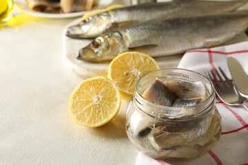 Concept of tasty lunch with fresh herring fish on white textured background
