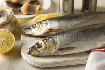 Concept of tasty lunch with fresh herring fish on white textured background