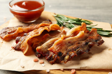 Concept of tasty snack with board of fried bacon