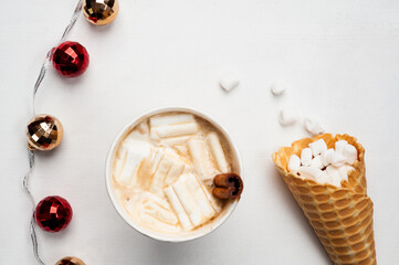 a cup of hot coffee on the table. Homemade waffles with marshmallows and cinnamon. Cozy atmosphere. New Year's and Christmas