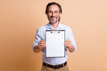 Photo of handsome agent guy hold clipboard demonstrate empty space wear eyewear shirt isolated beige color background