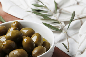 Composition of green olives and bottles of olive oil on the background. Space for text.
