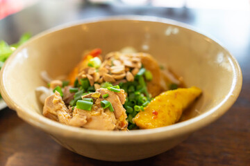 Mi Quang: is a Vietnamese noodle dish that originated from Quang Nam Province in central Vietnam. Mi quang and raw material as pork meat, salad, vegetable, chilli, lemon, yellow noodle, dried shrimp.