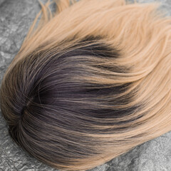Wigs, natural and synthetic hair. Women's beauty concept. Close up photo of wig, hair for ladies