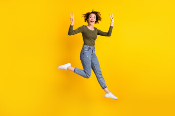 Fototapeta na wymiar Full body photo of energetic girl jump make v-sign wear sweater isolated over shine yellow color background