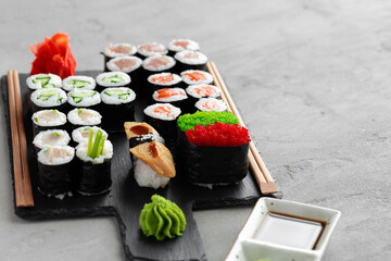 Maki sushi set served on black stone tray