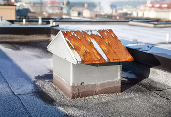 Rusty roof vent in need of repair. Flat roof with 2-ply SBS or modified bitumen roofing system....