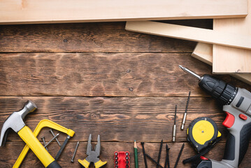 Construction tools and wooden bars on the wooden workbench flat lay background with copy space.