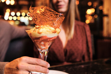 Young couple eating dessert on a date.