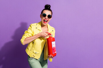 Photo of young happy crazy excited girl woman female with open mouth hold red fire extinguisher isolated on violet color background