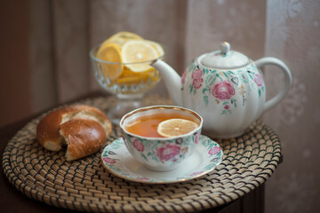 Obraz na płótnie Canvas Still-life. Tea with lemon slices and a pie.