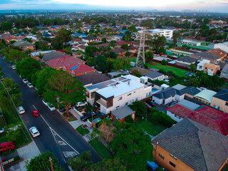 Obraz premium Panoramic Aerial View of Sydney Western suburbs showing house roof tops roads cars and other buildings 