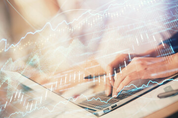 Double exposure of woman hands typing on computer and forex chart hologram drawing. Stock market invest concept.