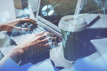 Double exposure of woman hands typing on computer and forex chart hologram drawing. Stock market invest concept.