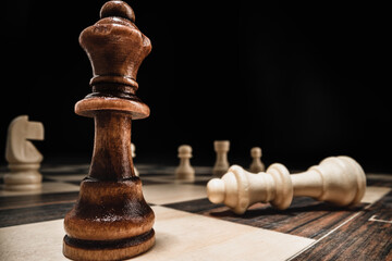 Chess game with chess pieces against black background