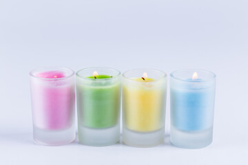 close up view of colorful candles over white background