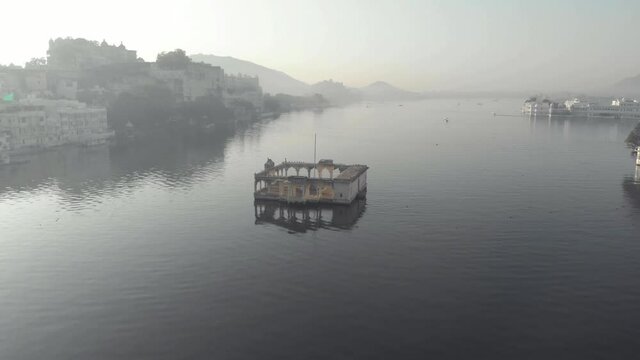 Top view of Mohan Mandir Temple on the Pichola Lake, in Udaipur, Rajasthan, India - Aerial low angle Fly-over