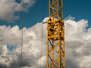 Orange crane stand,  blue sky clouds in background - Powered by Adobe