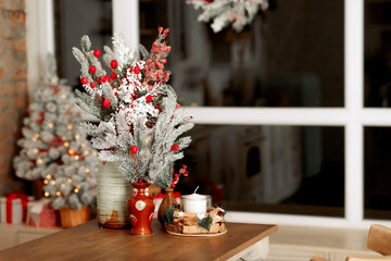 New Year's decor. Christmas trees and branches, decorations on the table, in the kitchen and at home.