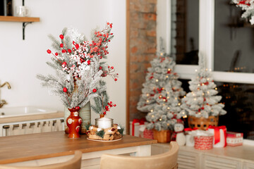 New Year's decor. Christmas trees and branches, decorations on the table, in the kitchen and at home.