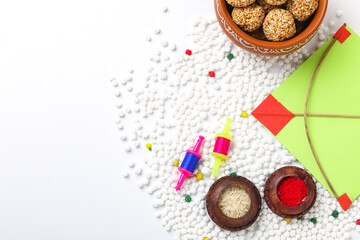 Indian festival makar sankranti concept : tilgul and sesame seed ball or laddo on white background