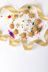 Indian festival makar sankranti concept : tilgul and sesame seed ball or laddo on white background