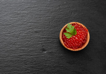 fresh grainy red chum salmon caviar in a wooden plate, delicious and healthy food