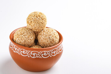 Indian sweet for traditional festival makar sankranti :Rajgira laddu made from Amaranth seed in Bowl on white background
