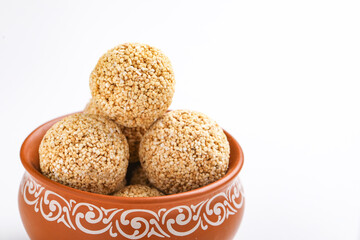 Indian sweet for traditional festival makar sankranti :Rajgira laddu made from Amaranth seed in Bowl on white background
