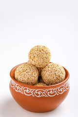 Indian sweet for traditional festival makar sankranti :Rajgira laddu made from Amaranth seed in Bowl on white background